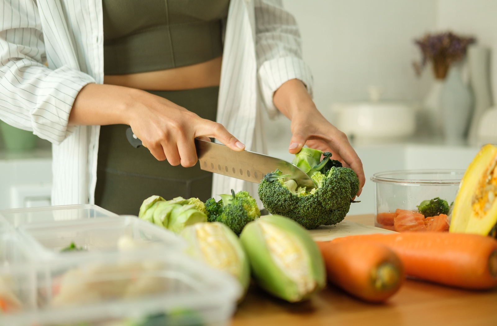 A person cooking with healthy foods that support aging.